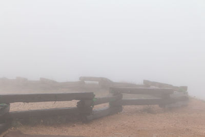 Man on foggy weather against sky