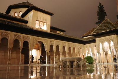 Low angle view of illuminated building against sky