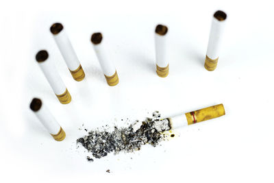 High angle view of cigarette smoking on white background