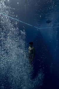 High angle view of woman swimming in sea