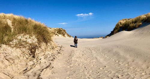 Full length of man on beach against sky