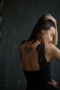 Rear view of woman with tattoo