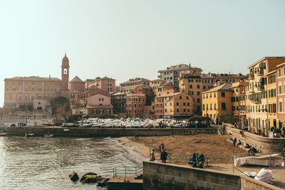 Buildings in city against clear sky