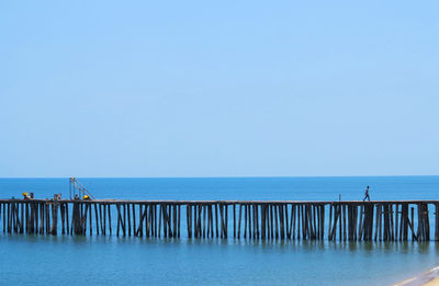 Pier over sea against clear sky