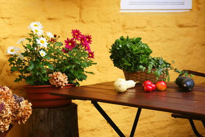 Vegetables on table by flower vase