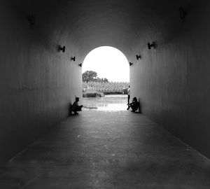 People sitting in tunnel