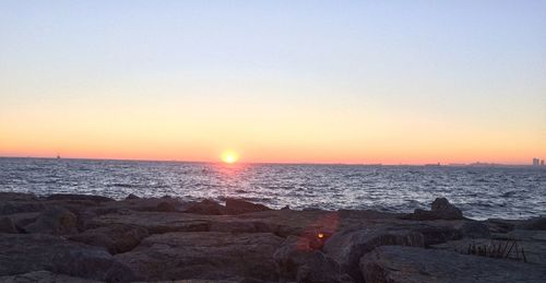 Scenic view of sea against clear sky during sunset