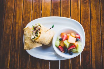 Directly above shot of food served on wooden table