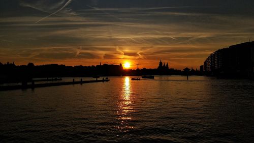 Scenic view of river against sky during sunset