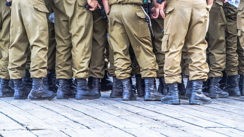 Low section of people standing on tiled floor