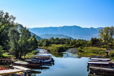 Scenic view of lake and mountains against clear sky