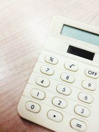 Directly above shot of calculator on wooden table