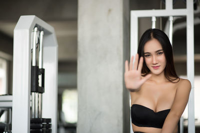 Young woman gesturing in gym