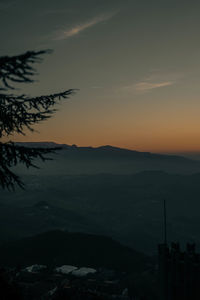 Scenic view of silhouette mountains against sky at sunset