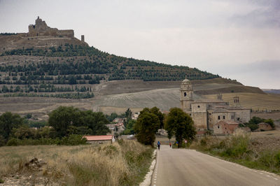 Empty road with buildings in background