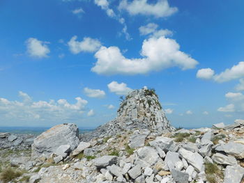 Rock formations by sea against sky