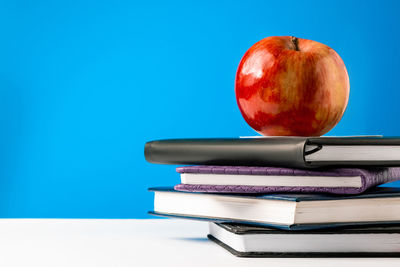 Close-up of apple on blue background