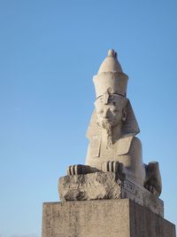 Low angle view of statue against clear blue sky