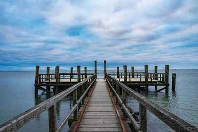 Pier on sea against sky