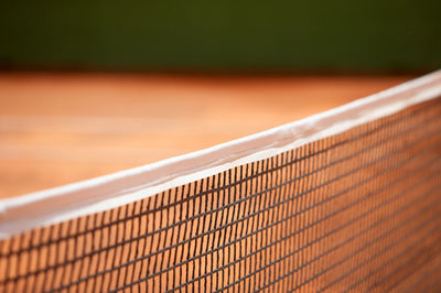 Empty tennis court during sunny day