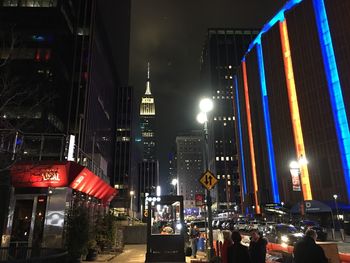 Illuminated city street and buildings at night