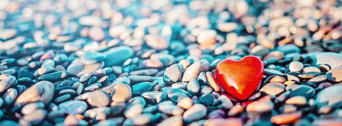 Close-up of heart shape stone on pebbles