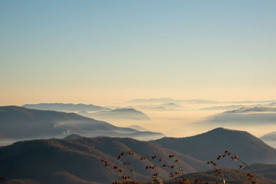 Scenic view of snowcapped mountains against sky during sunset