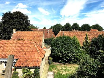 Houses and trees against sky