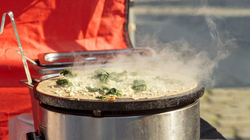 Demonstration cooking, chef making pancakes at naplavka street food market.