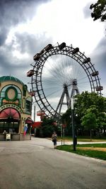 Ferris wheel against cloudy sky