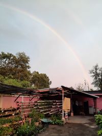 Scenic view of rainbow over buildings against sky
