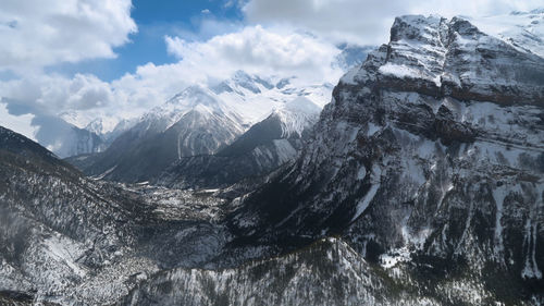 Scenic view of snowcapped mountains against sky