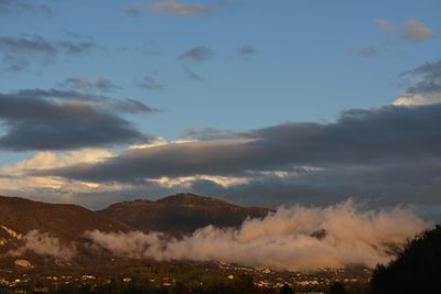 Scenic view of mountains against sky at sunset