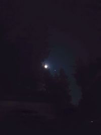 Low angle view of moon in sky at night