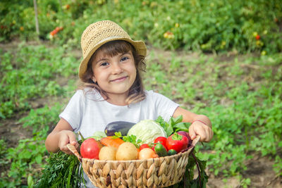 Portrait of smiling woman holding fruits