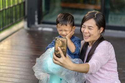 Asian single mom with son are selfie together when living in loft house for self learning