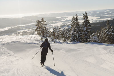 Full length of person skiing on snowcapped mountain