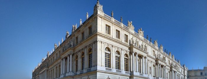 Low angle view of building against blue sky on versailles 