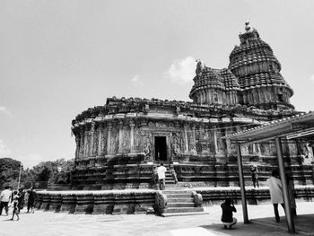 People in temple building against sky