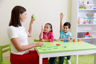 Teacher teaching kids at classroom