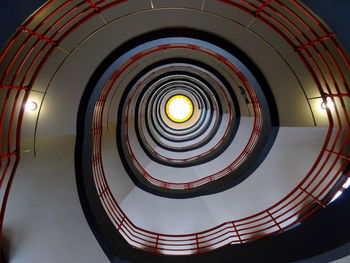 Directly below shot of illuminated spiral staircases
