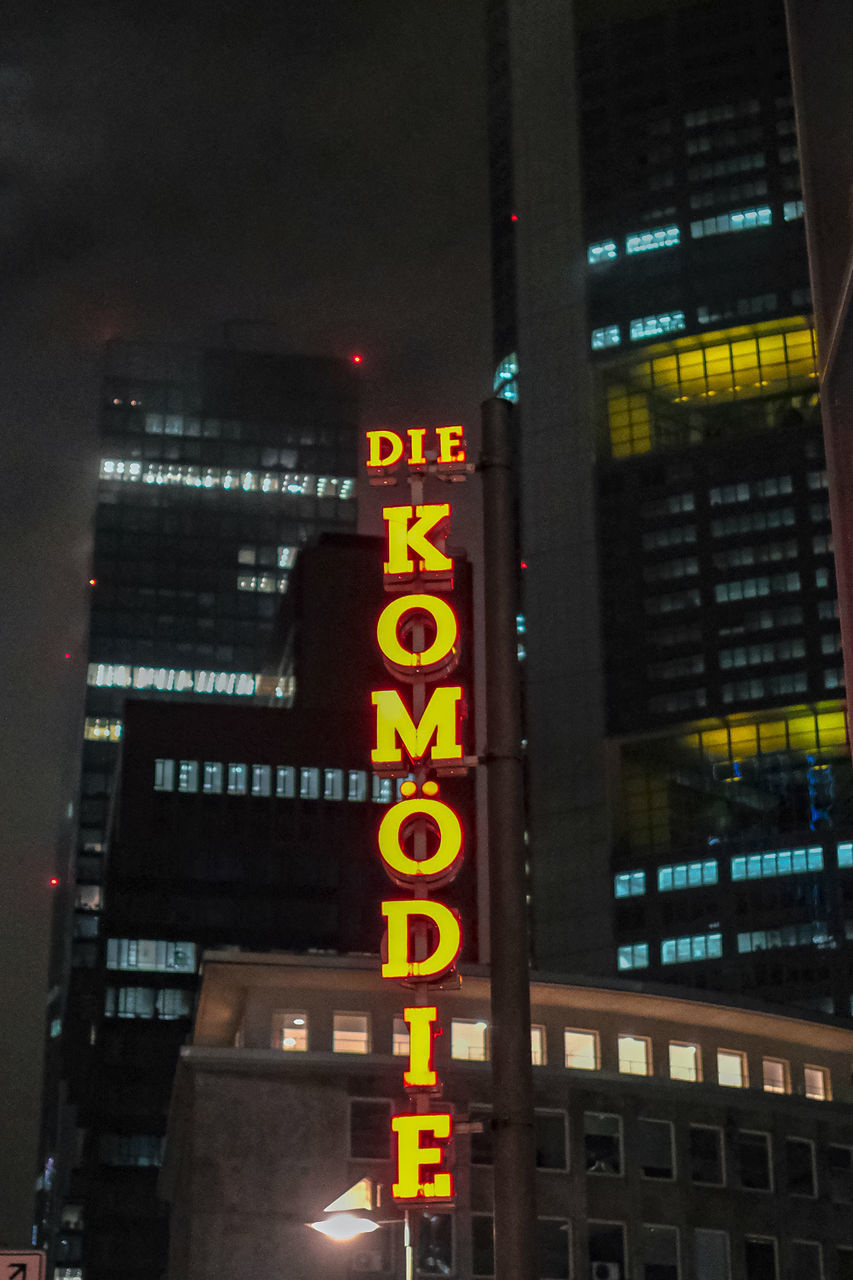 LOW ANGLE VIEW OF ILLUMINATED TEXT ON BUILDING AT NIGHT