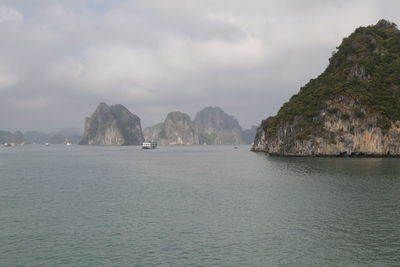 Scenic view of sea and mountains against sky