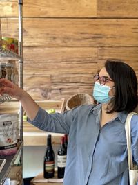 Full length portrait of woman wearing mask