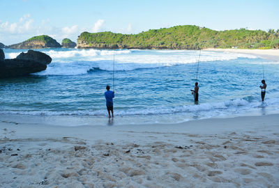 People fishing at beach