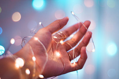 Close-up of hand holding illuminated lights