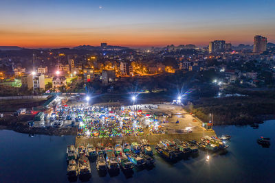 High angle view of illuminated buildings against sky at night