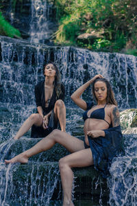 Full length portrait of young woman in water