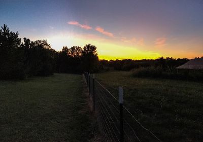 Scenic view of field against sky during sunset