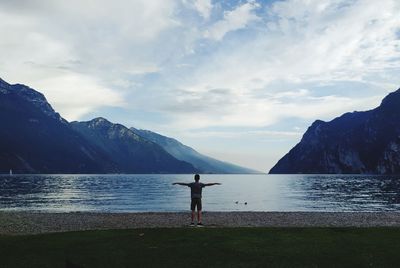 Scenic view of lake by mountains against sky